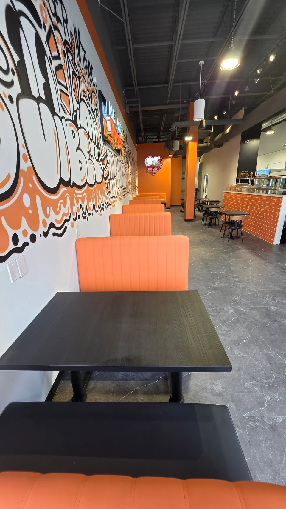 Orange booths and mural inside the Kanata restaurant